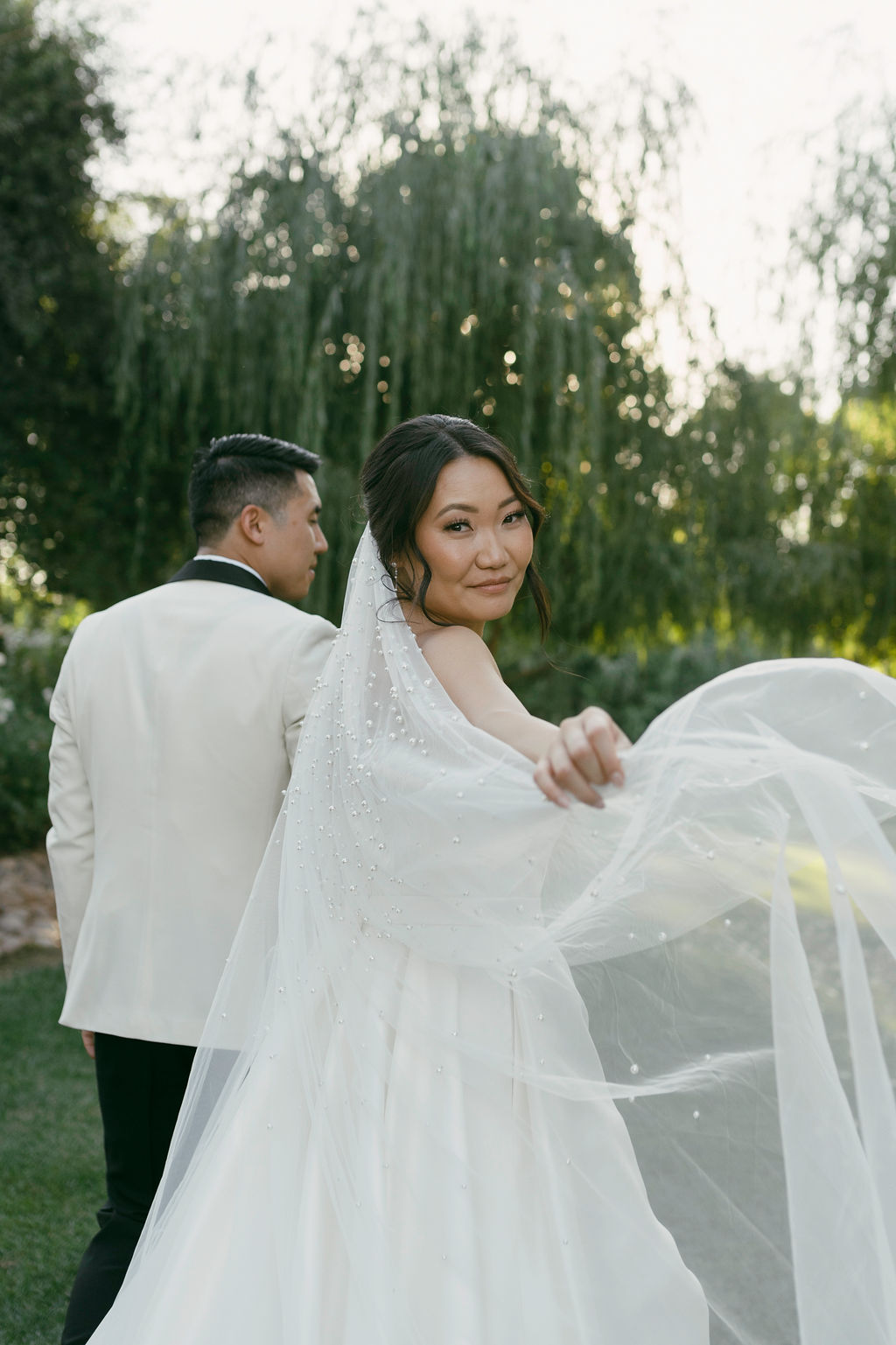 bride and groom posing for their outdoor wedding portraits in california.