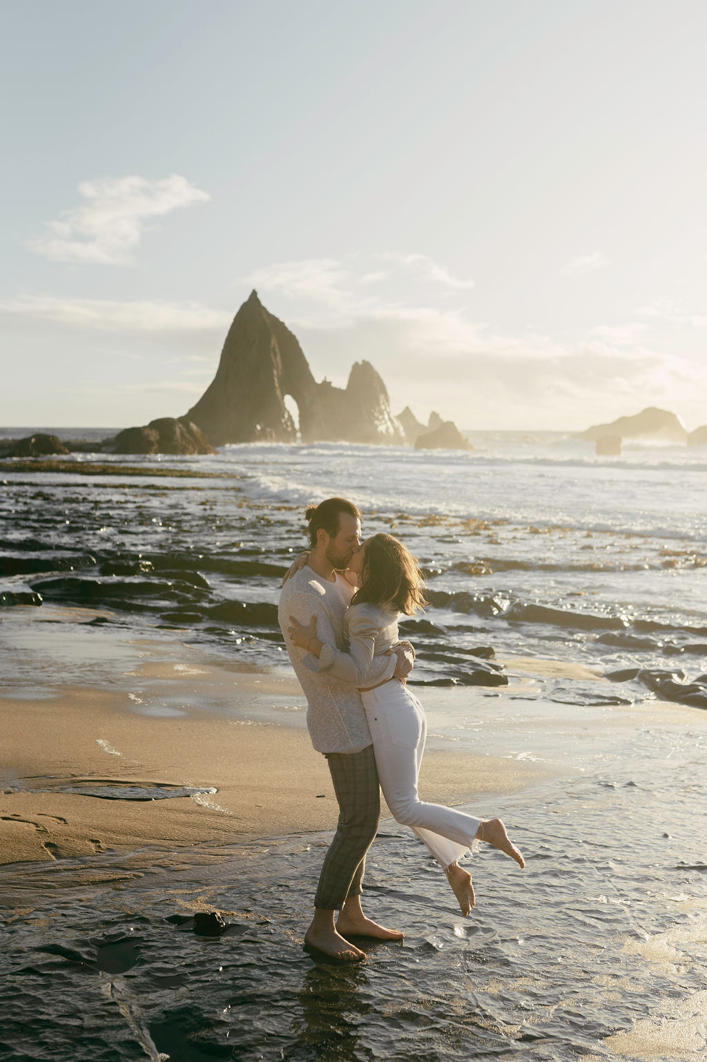 Couple posing in half moon bay for their engagement session