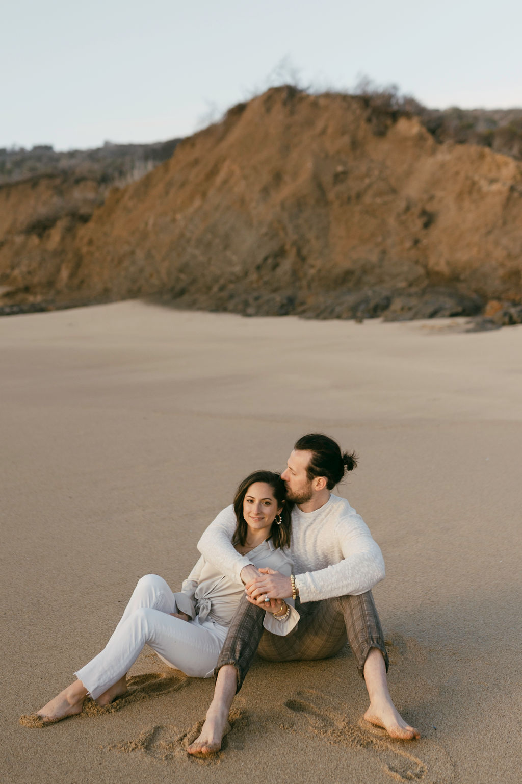 Couple posing in half moon bay for their engagement session