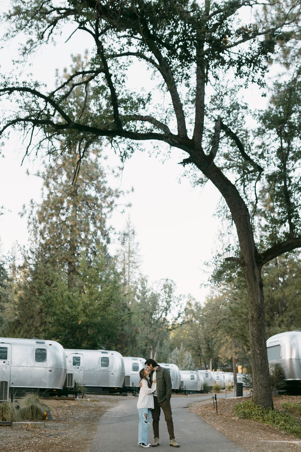 couple posing for their engagement photos at a campsite near yosemite
