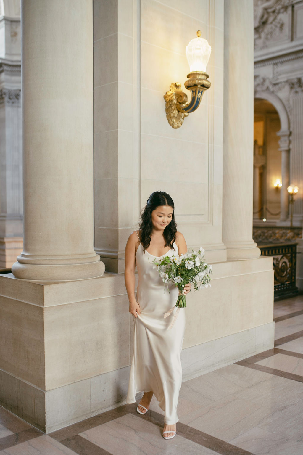 bride posing for her elopement photos - sf city hall elopement