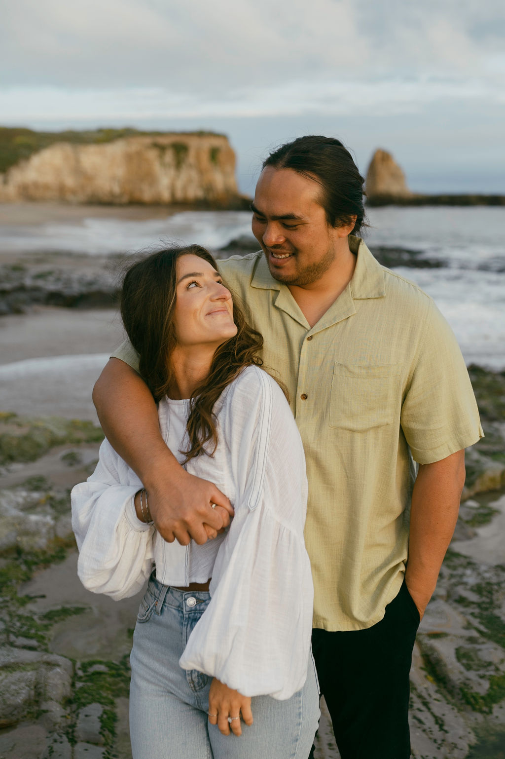 couple posing on the beach in santa cruz for their engagement photoshoot - sydnee marie photography