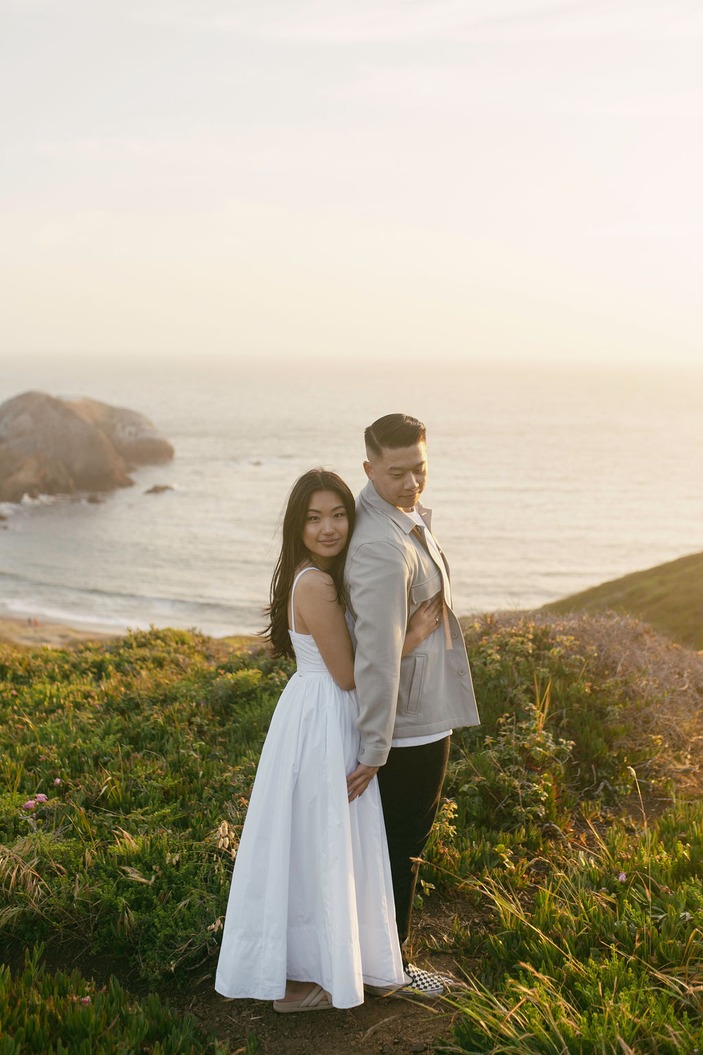 couple posing on the beach in san francisco for their engagement photos