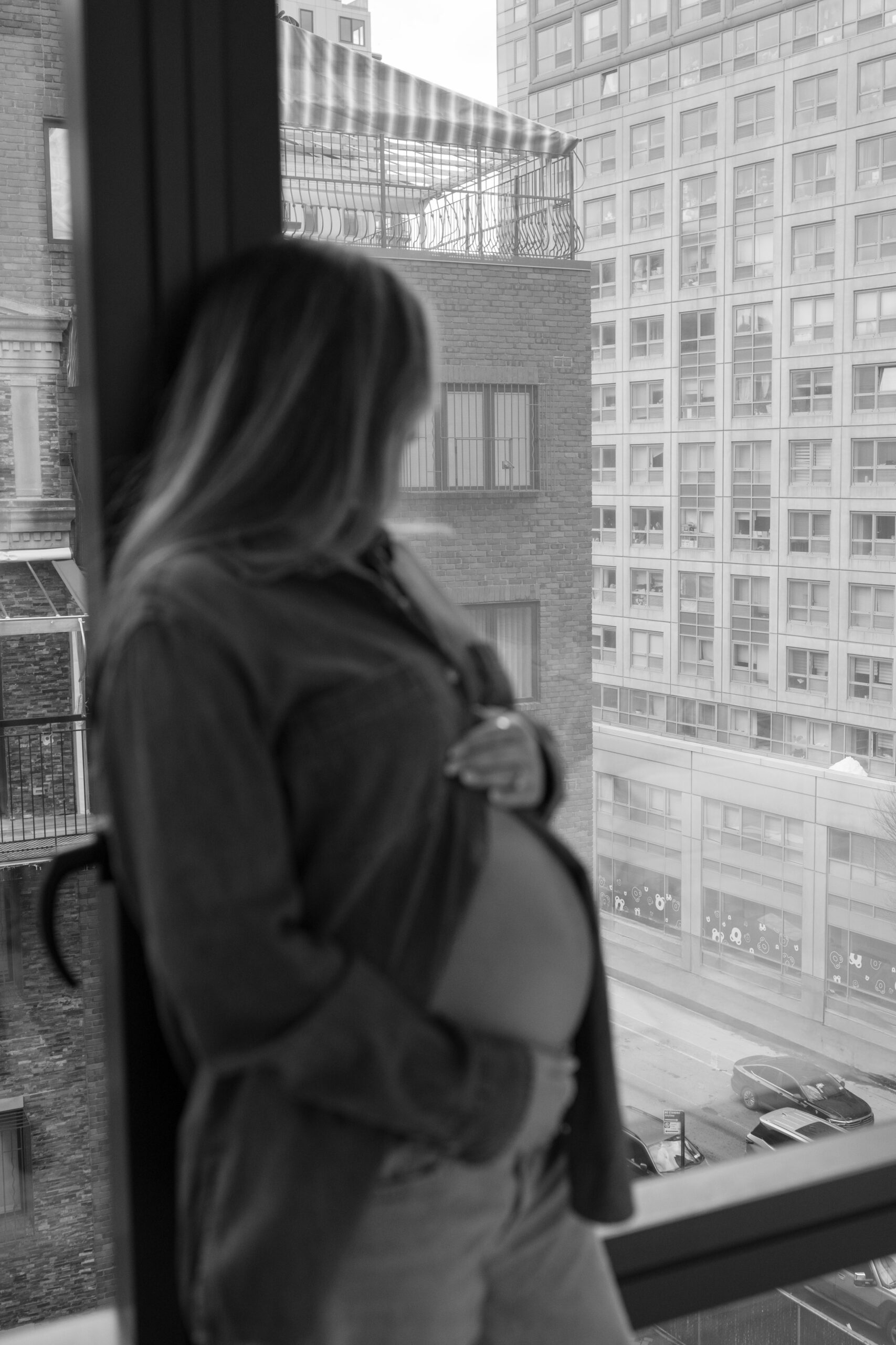 pregnant woman looking out the window